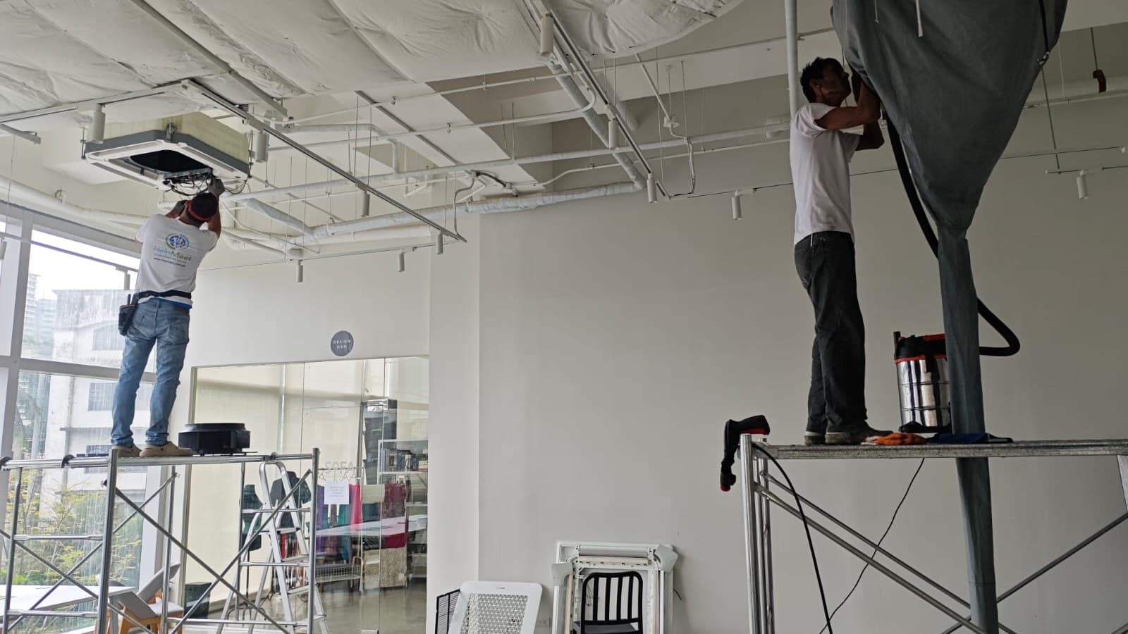 HelpMeet technician servicing aircon with safety equipment
